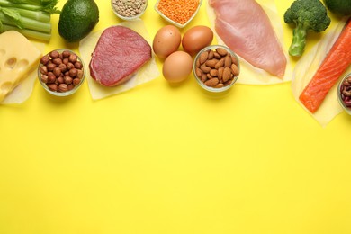 Set of products rich in amino acids on yellow background, flat lay. Space for text
