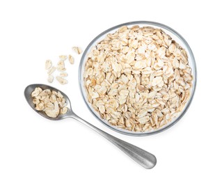 Photo of Raw oatmeal, glass bowl and spoon on white background, top view