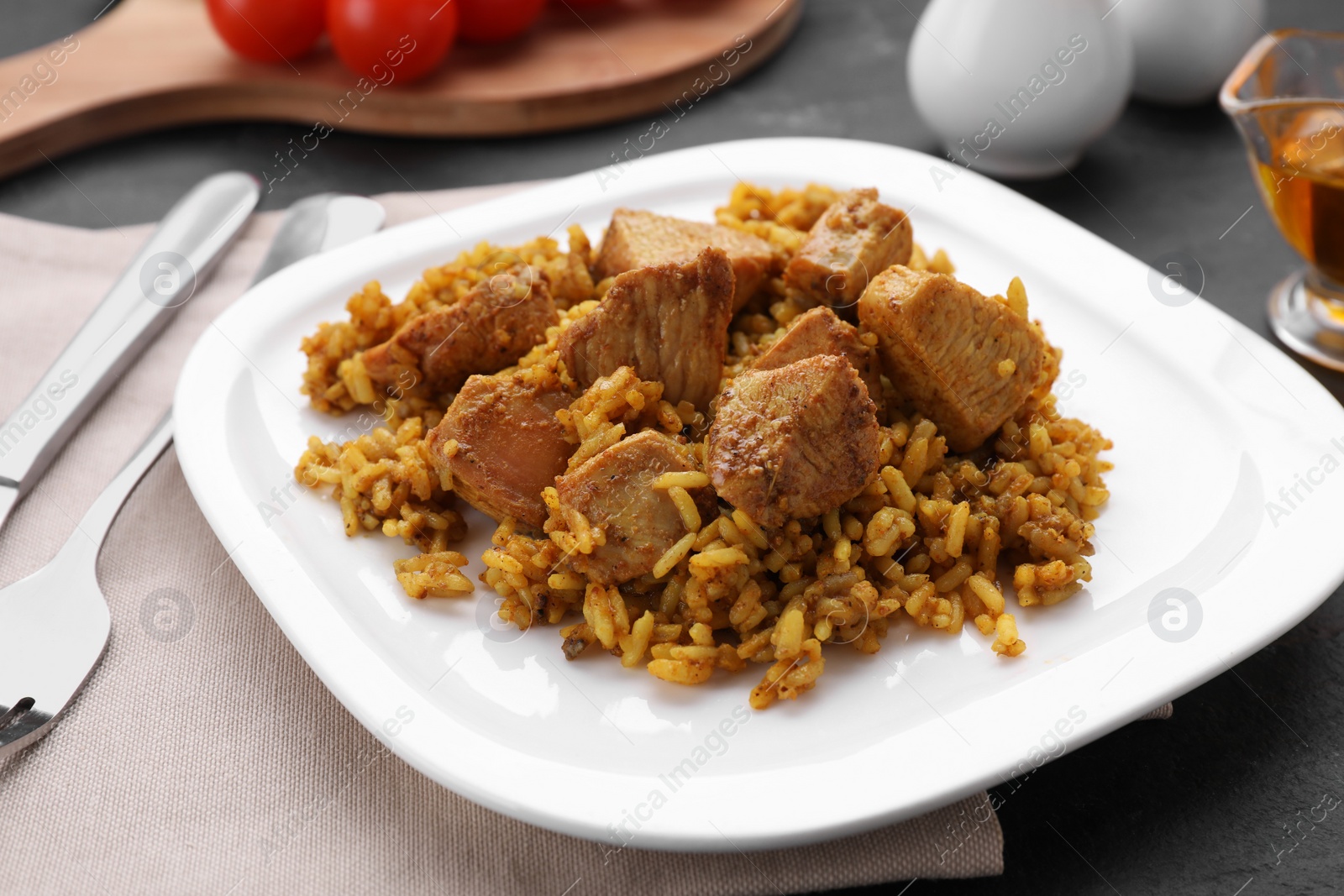 Photo of Delicious rice with chicken served on table, closeup