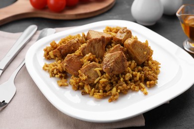 Photo of Delicious rice with chicken served on table, closeup