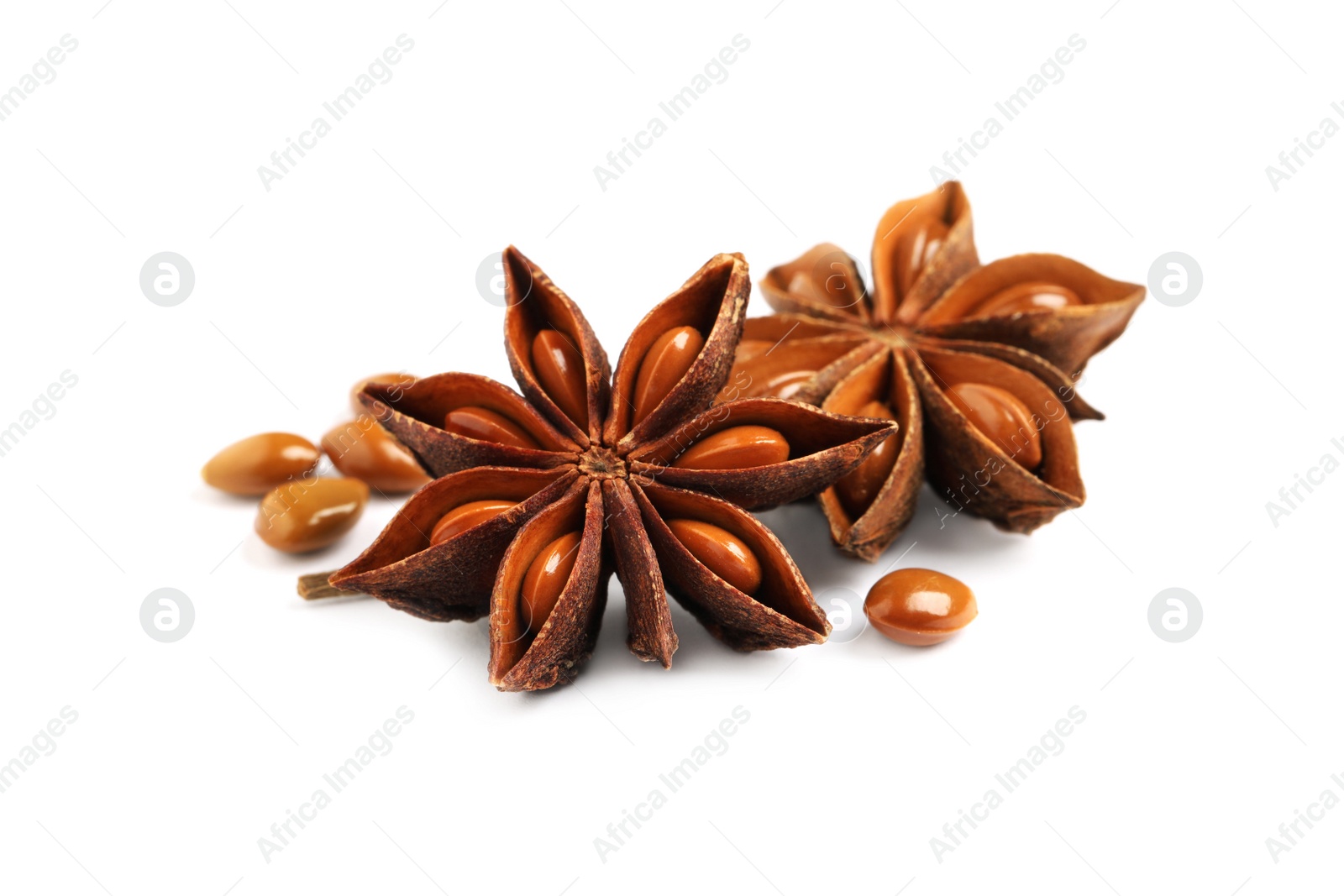 Photo of Dry anise stars with seeds on white background