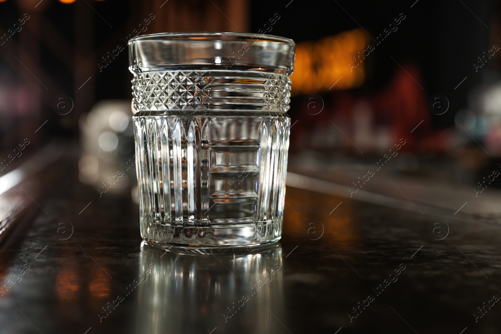 Photo of Empty clean glass on counter in modern bar