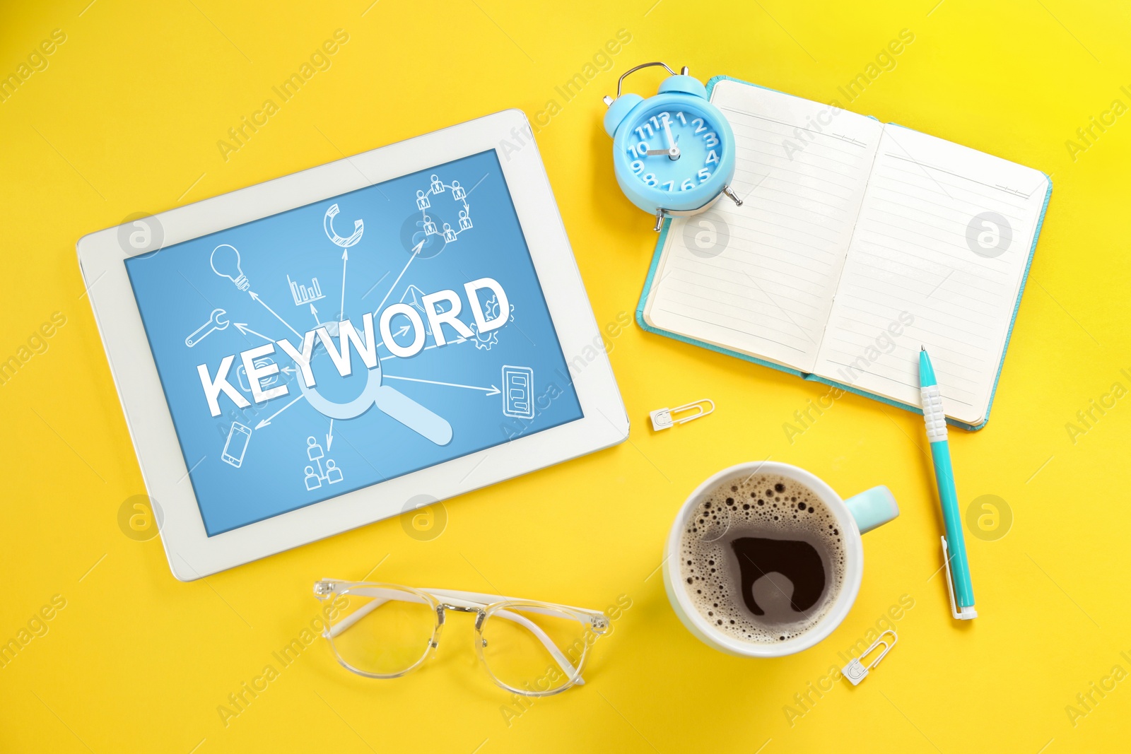 Image of Modern tablet with word KEYWORD and cup of coffee on yellow background, flat lay