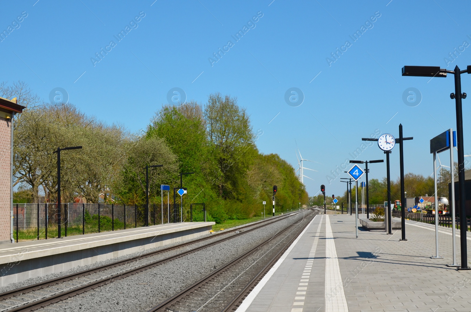 Photo of Empty platform of railway station on sunny day