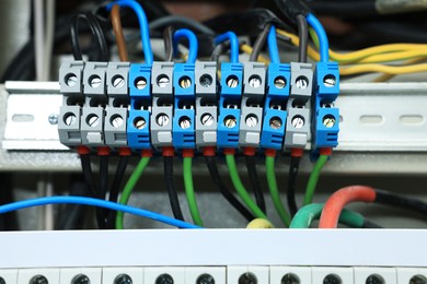 Photo of Electrical panel with many wires in fuse box, closeup