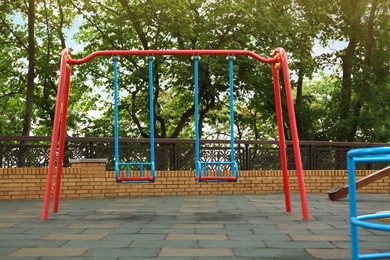 Photo of Children's playground with new colorful swing set