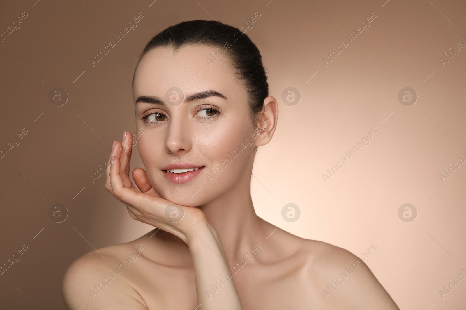 Photo of Portrait of beautiful young woman on light brown background. Space for text