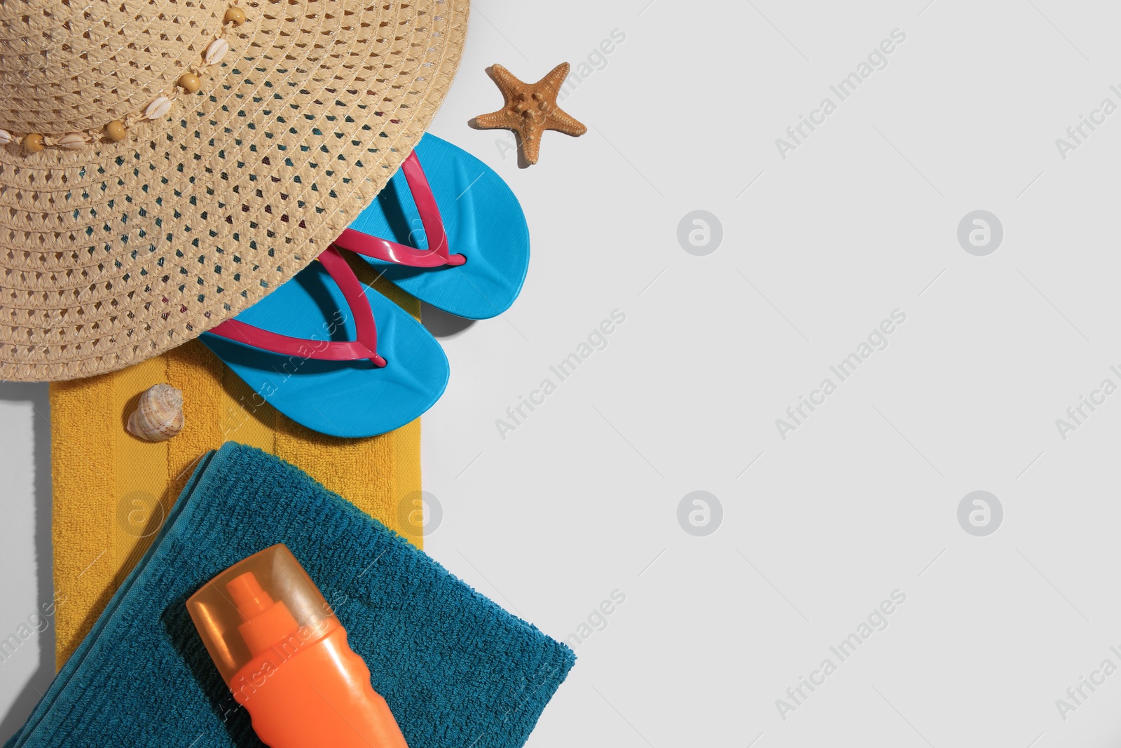 Photo of Flat lay composition with beach accessories on white background, space for text