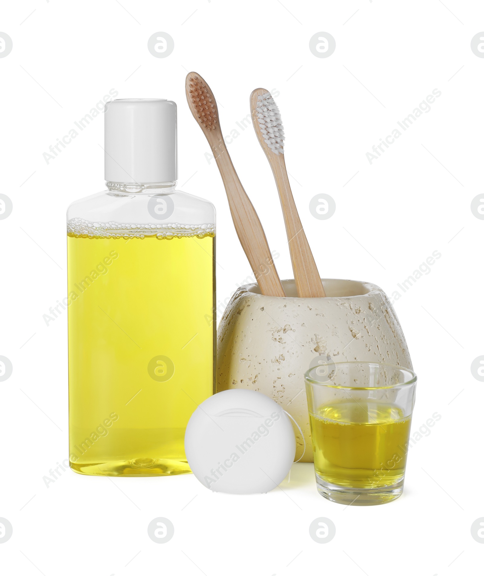 Photo of Mouthwash, toothbrushes and dental floss isolated on white