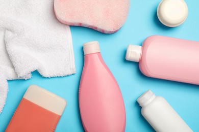 Flat lay composition with baby cosmetic products on light blue background