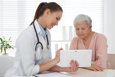 Photo of Senior woman visiting doctor in modern office