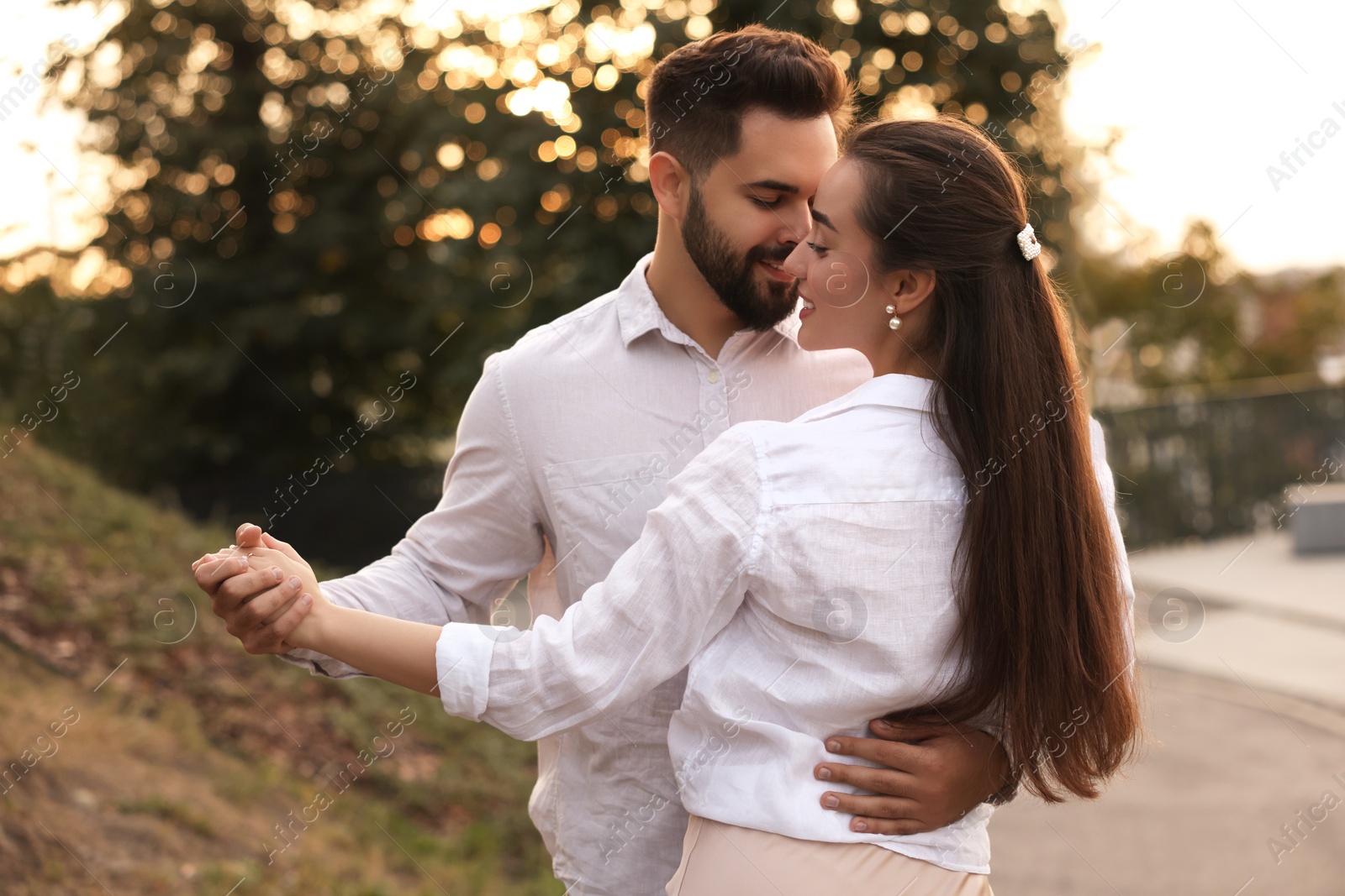 Photo of Lovely couple dancing together outdoors. Romantic date