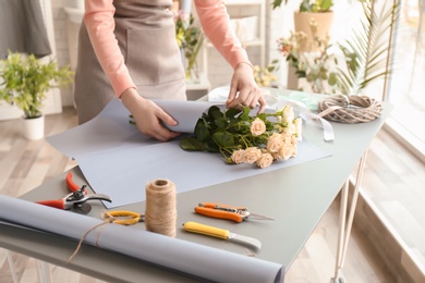 Female florist creating bouquet at workplace