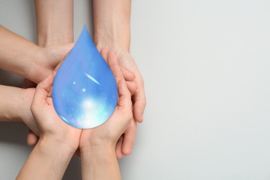 Image of People holding paper water drop on light grey background, top view. Space for text