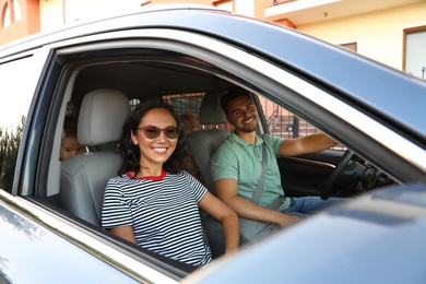 Photo of Happy young couple traveling by family car on summer day