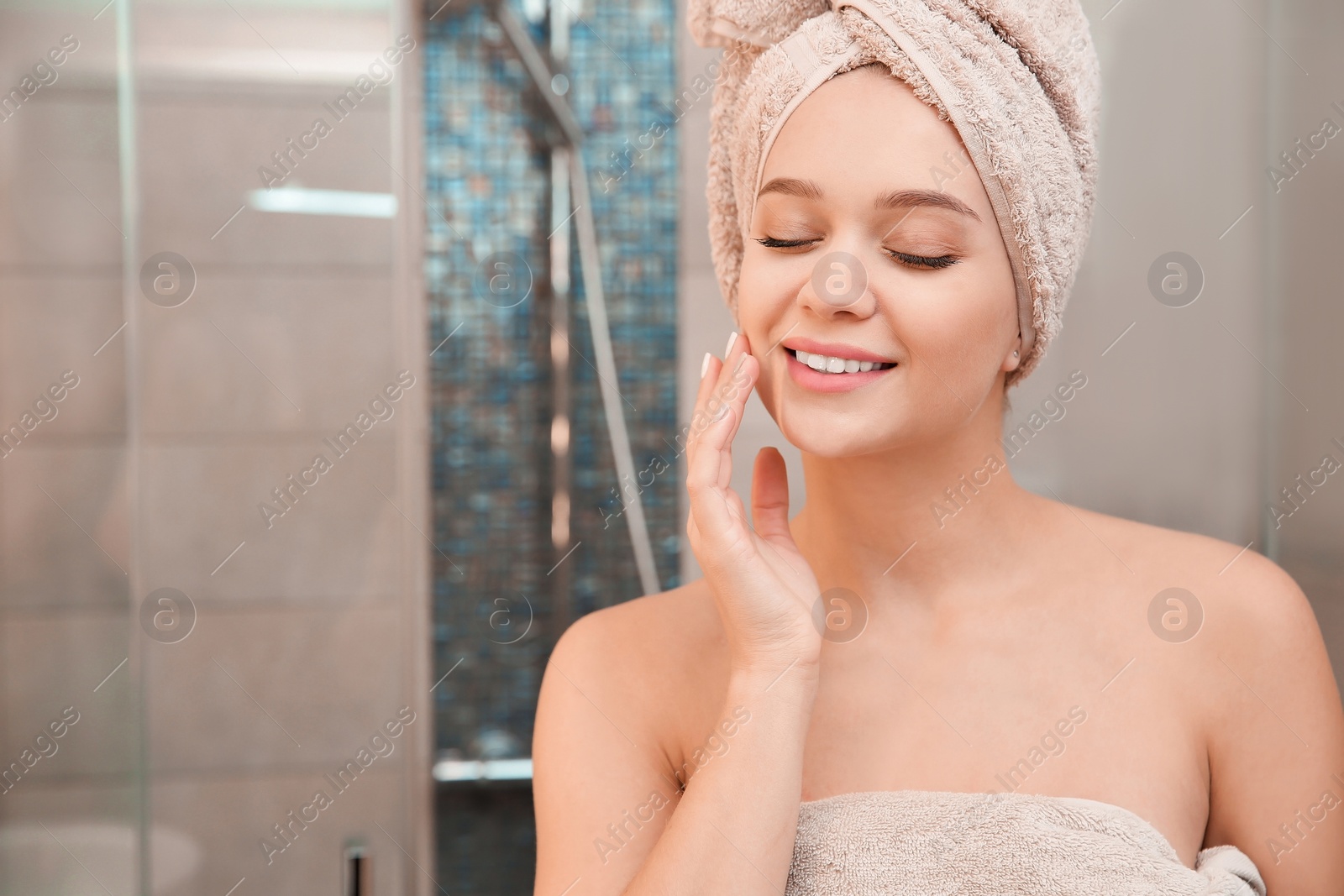 Photo of Portrait of beautiful woman with clean towels in bathroom