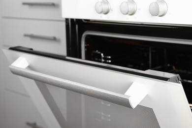 Photo of Open empty electric oven in kitchen, closeup