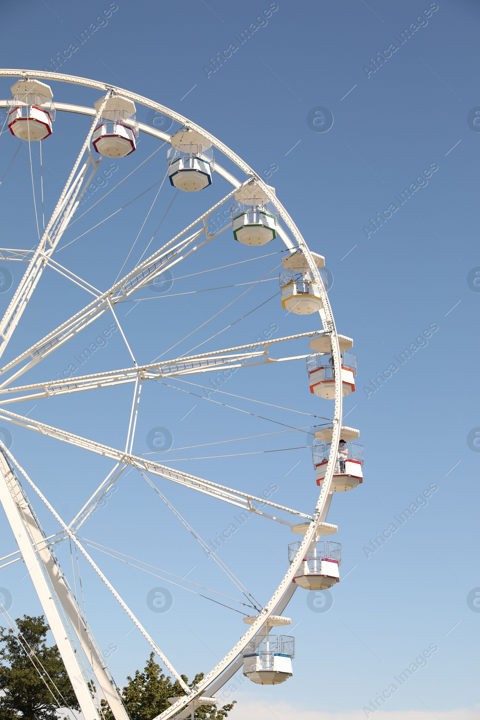 Photo of Beautiful white ferris wheel against blue sky