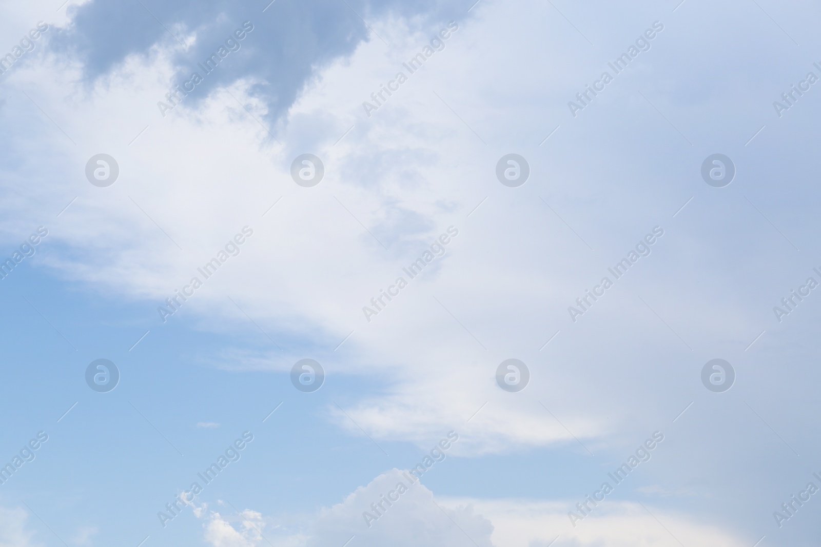 Photo of Beautiful fluffy clouds on light blue sky as background