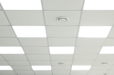 Photo of White ceiling with lighting in office room