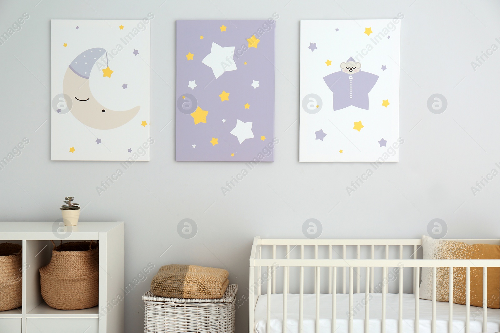Photo of Baby room interior with crib and cute posters on wall