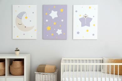 Baby room interior with crib and cute posters on wall