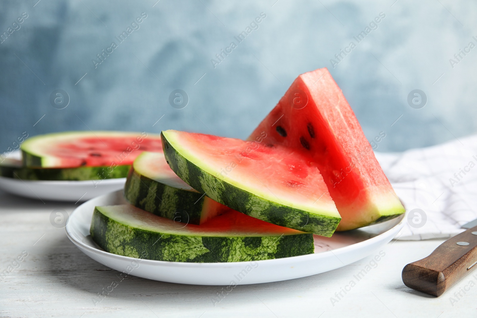 Photo of Plate with juicy watermelon slices on table