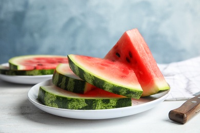 Photo of Plate with juicy watermelon slices on table