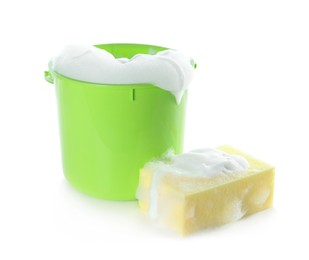 Plastic bucket with foam and sponge on white background. Cleaning supplies