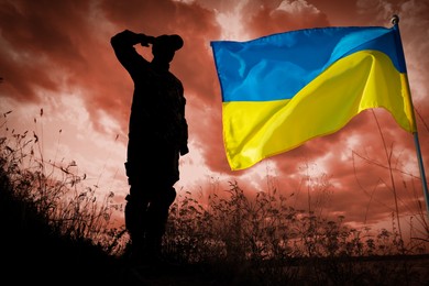 Image of Stop war in Ukraine. Silhouette of soldier saluting to Ukrainian flag outdoors, toned in red