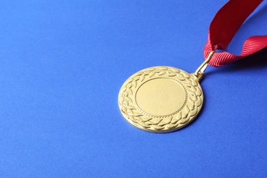 Gold medal with space for design on color background. Victory concept