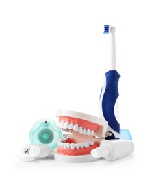 Photo of Composition with model of oral cavity and dental care items on white background. Healthy teeth