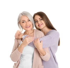 Portrait of young woman with her mature mother on white background