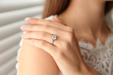 Young bride wearing beautiful engagement ring, closeup