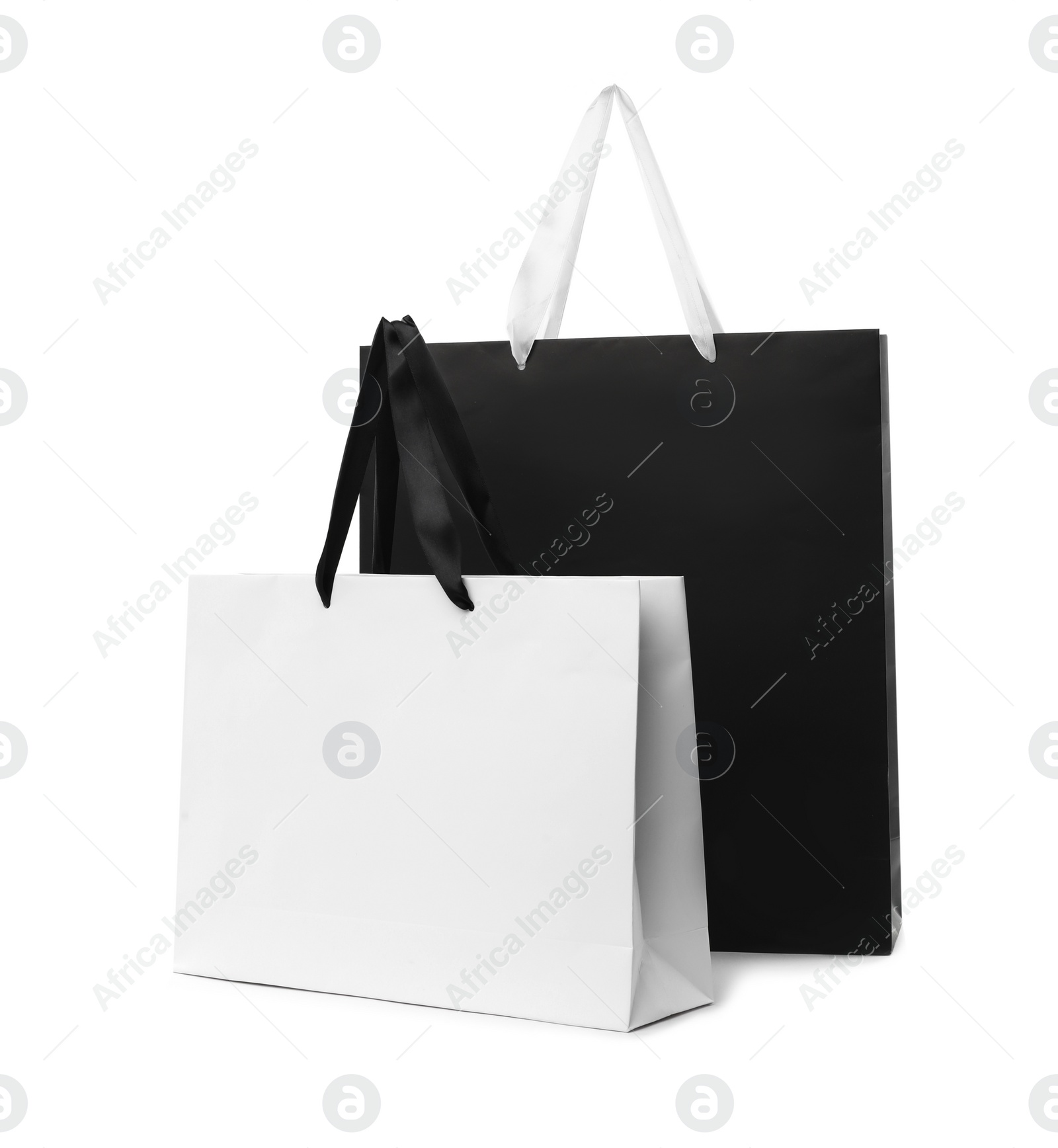 Photo of Paper shopping bags with handles on white background. Mockup for design