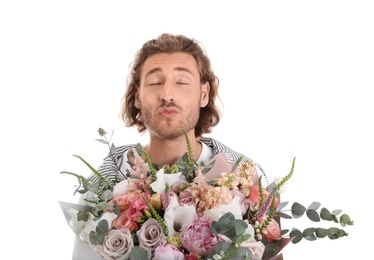 Photo of Young handsome man with beautiful flower bouquet on white background