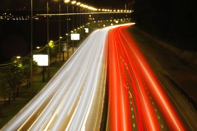 Road traffic, motion blur effect. View of car light trails at night