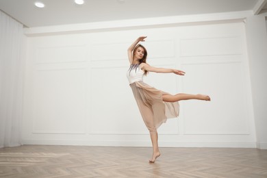 Photo of Beautiful professional dancer practicing moves in studio