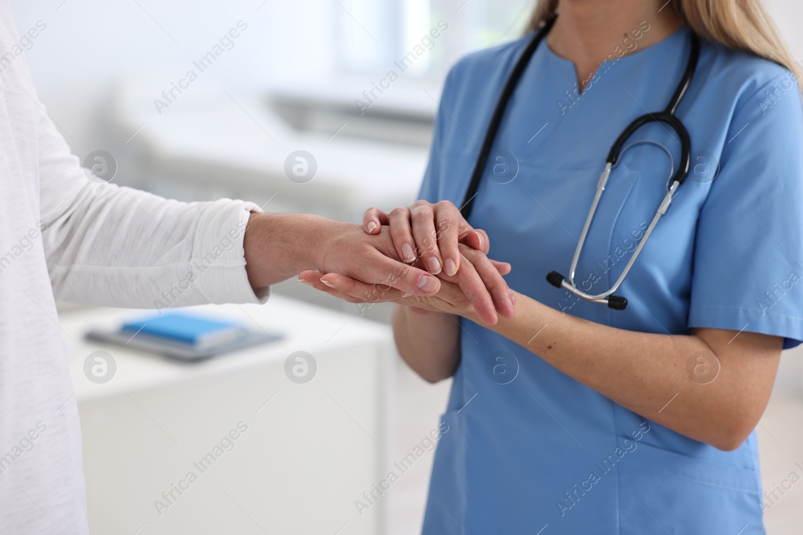 Photo of Professional doctor working with patient in hospital, closeup