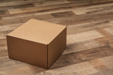 Photo of Cardboard box on wooden floor