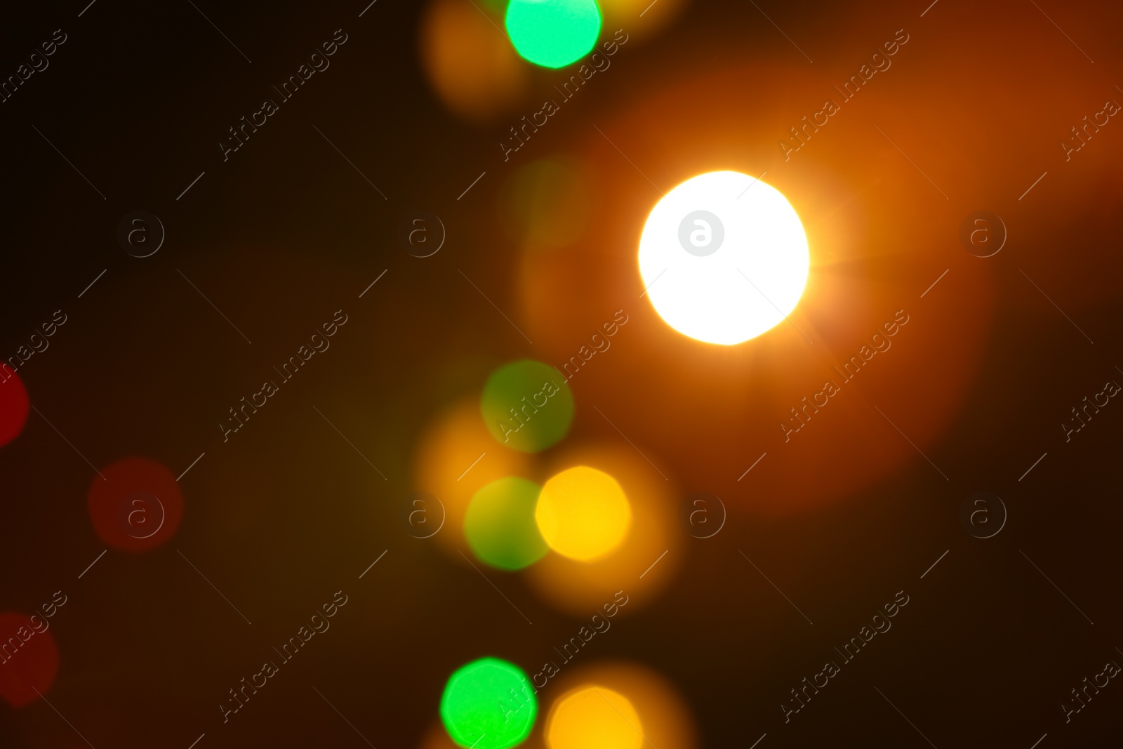 Photo of Blurred view of beautiful lights on dark background. Bokeh effect