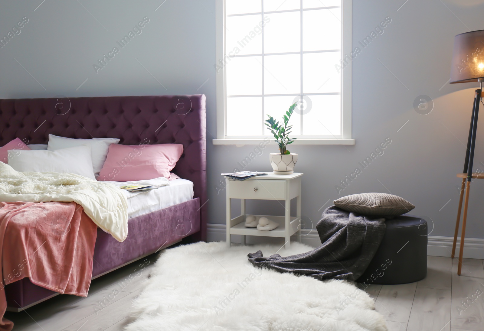 Photo of Stylish room interior with comfortable bed