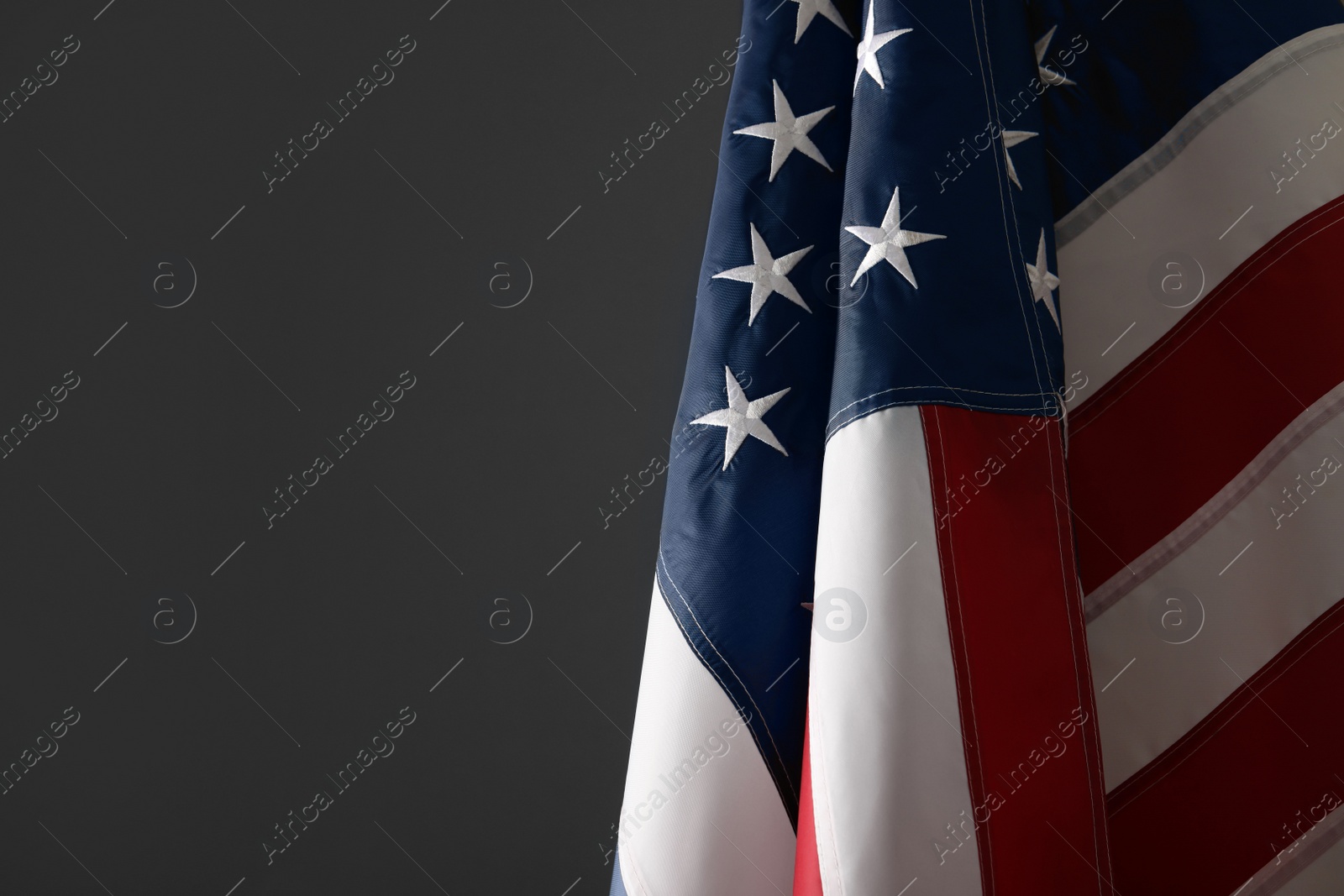 Photo of America flag on grey background, closeup with space for text. Memorial Day