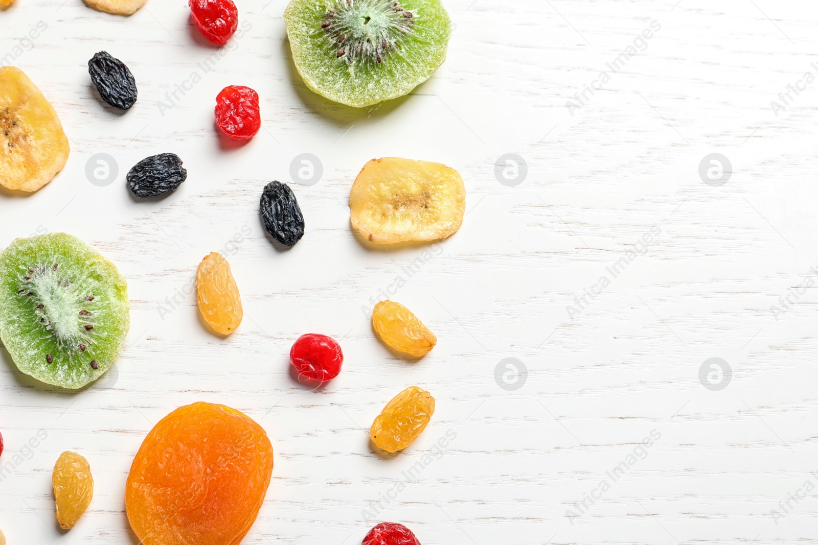 Photo of Flat lay composition with different dried fruits on wooden background, space for text. Healthy lifestyle