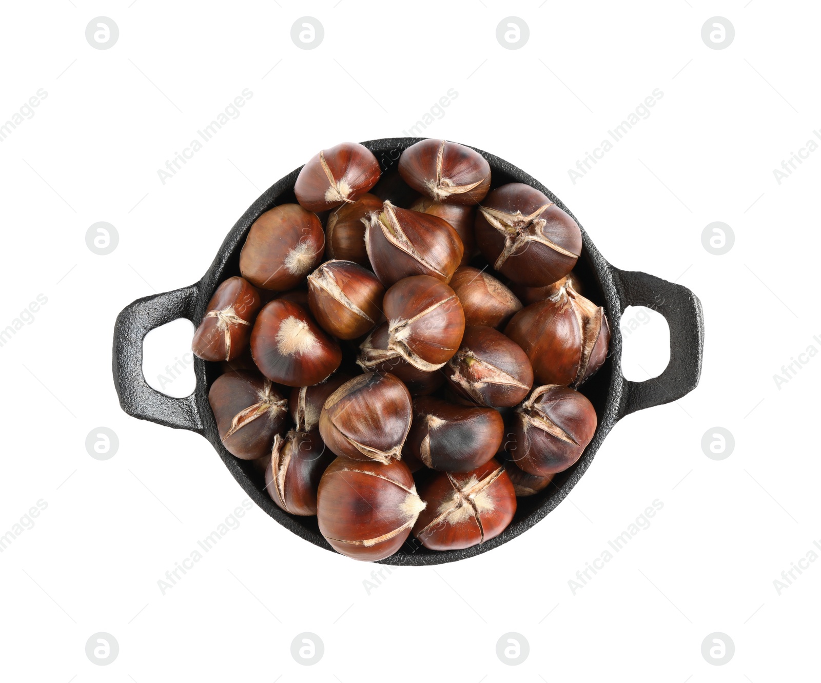 Photo of Delicious sweet roasted edible chestnuts in frying pan isolated on white, top view