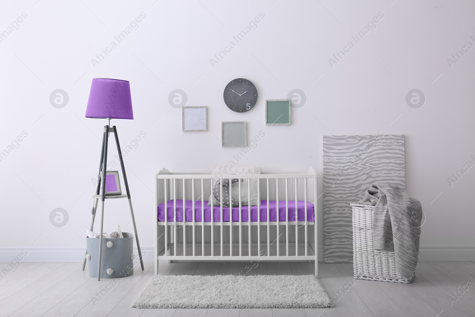 Photo of Baby room interior with crib near wall