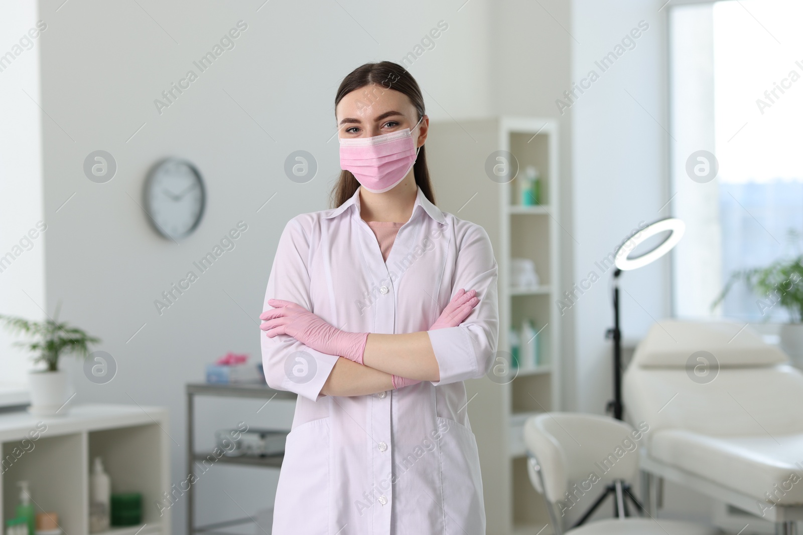 Photo of Cosmetologist in medical uniform in modern clinic
