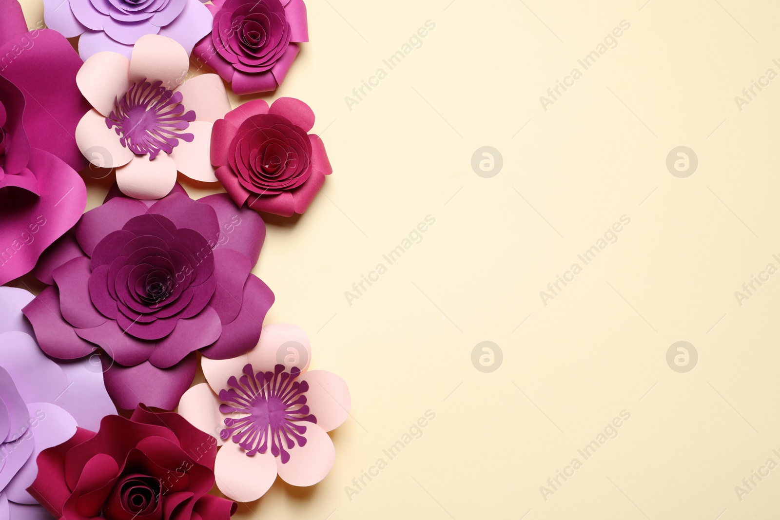 Photo of Different beautiful flowers made of paper on beige background, flat lay. Space for text