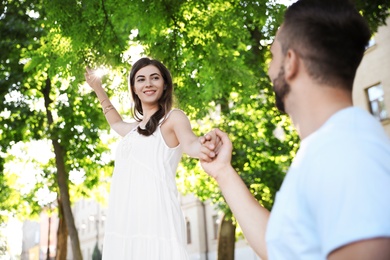 Photo of Lovely young couple dancing together in park on sunny day