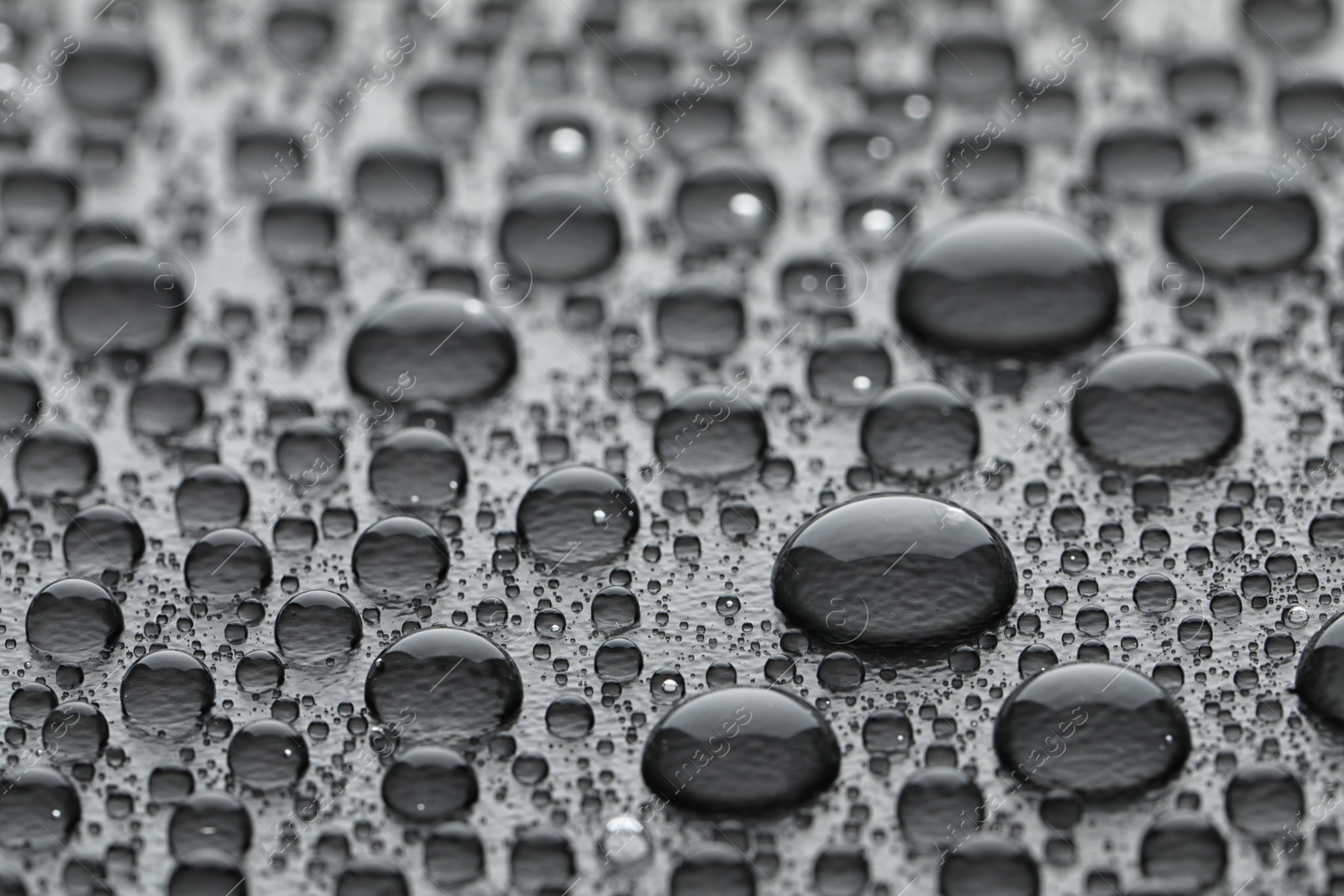 Photo of Water drops on grey background, closeup view